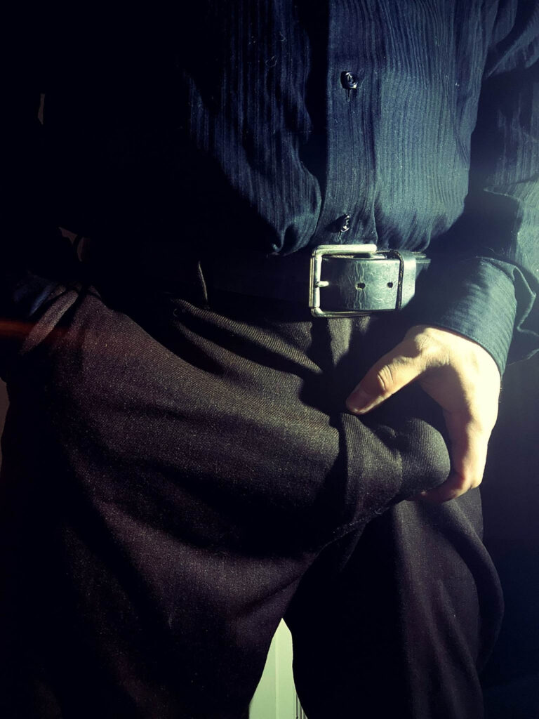 Close up shot of me grabbing myself through a pair of charcoal gray slacks.